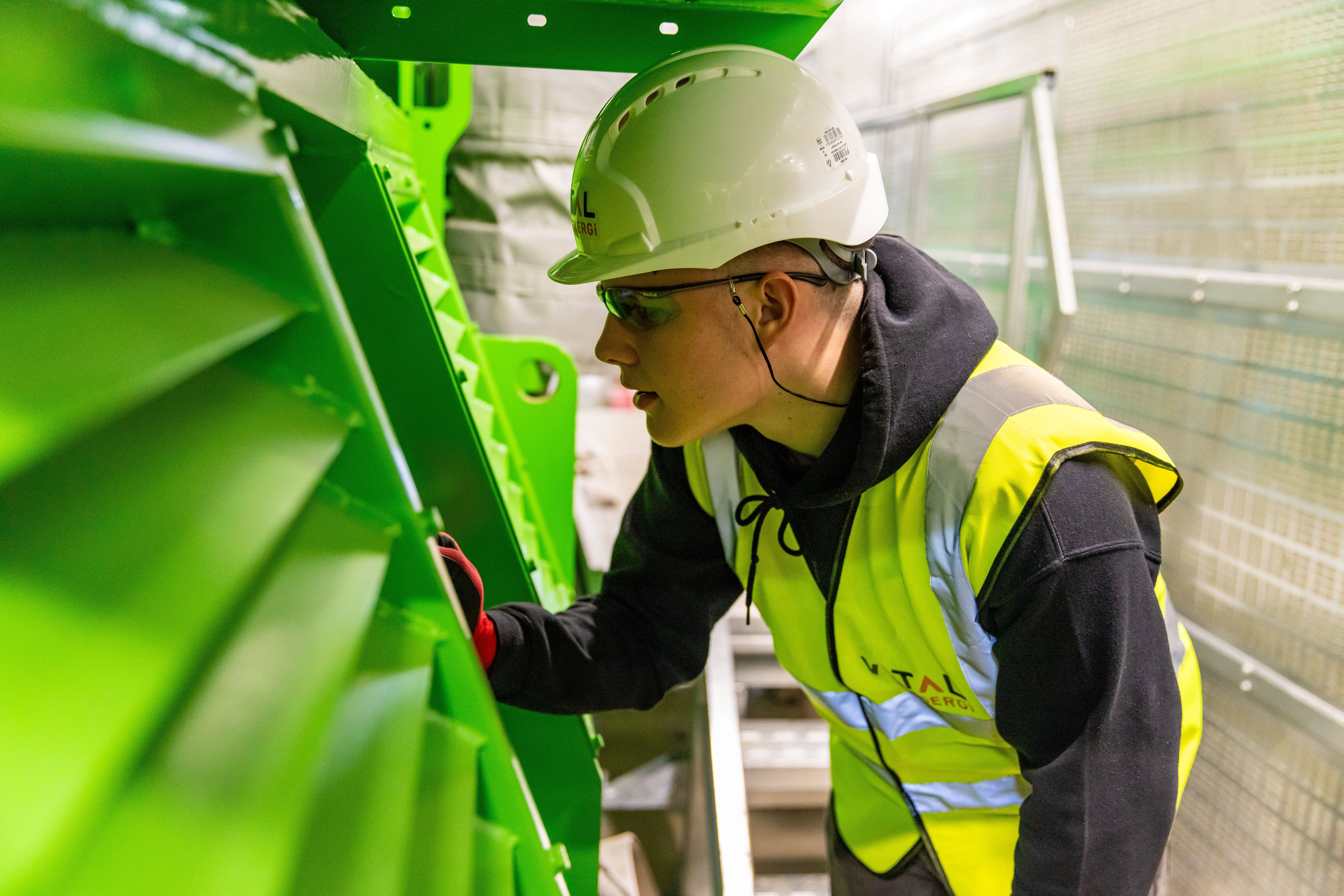 Service technician inspecting industrial equipment